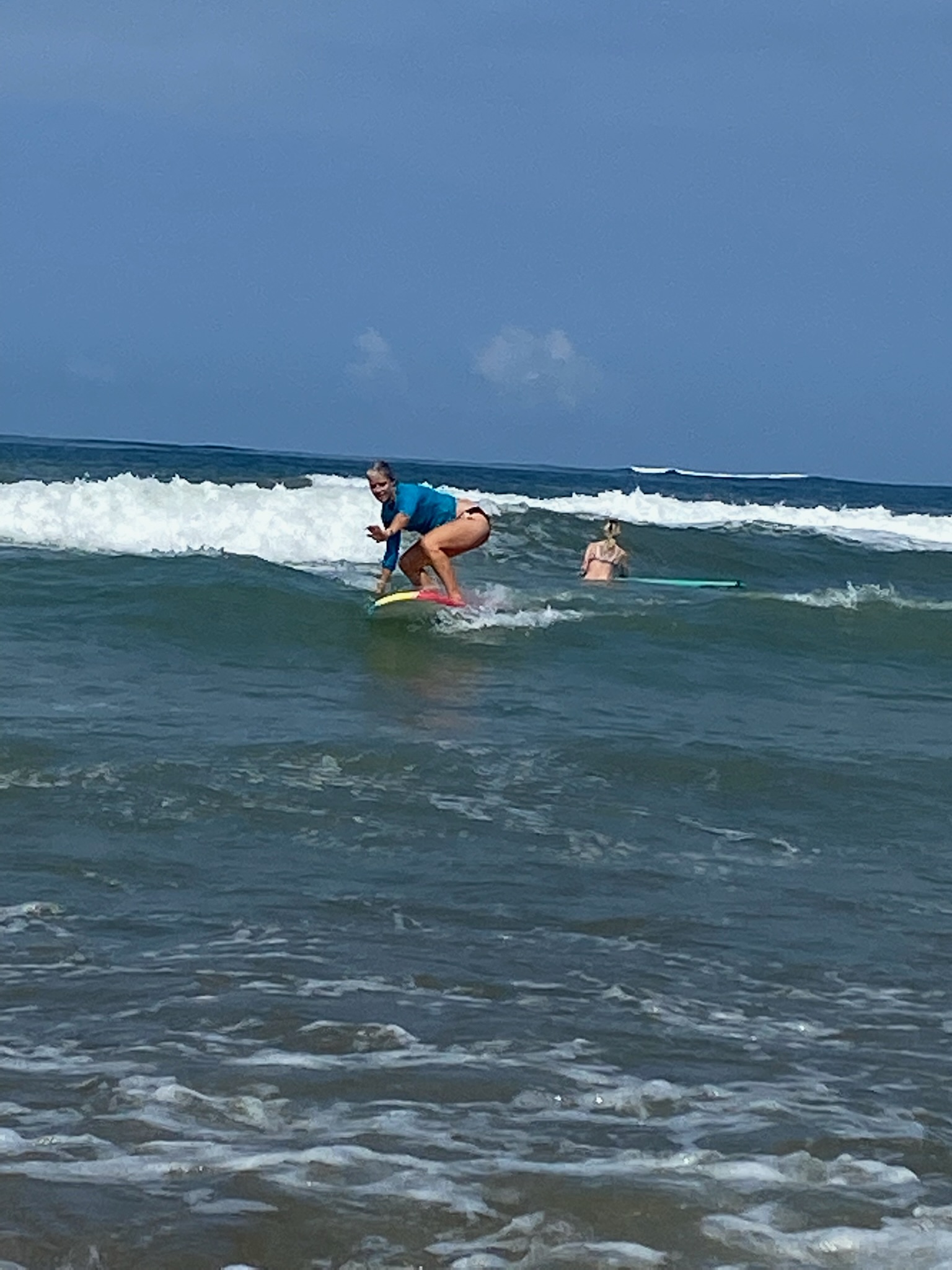 image of coach being active and surfing