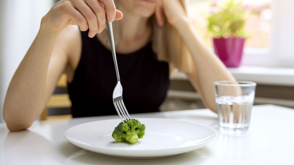 image of woman eating healthy food but not enough